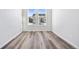 Bedroom with hard wood flooring and view of the neighbor's houses at 9688 Winterset Cir, Littleton, CO 80125