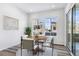 Bright dining area with large windows and sliding glass doors, perfect for entertaining and everyday meals at 9688 Winterset Cir, Littleton, CO 80125