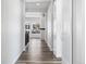 Long hallway with hard wood flooring and several doors at 9688 Winterset Cir, Littleton, CO 80125