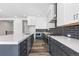Modern kitchen with a gray island, white cabinets, and sleek stainless steel appliances at 9688 Winterset Cir, Littleton, CO 80125