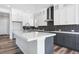 Modern kitchen features white cabinets, quartz countertops, and stainless steel appliances at 9688 Winterset Cir, Littleton, CO 80125