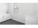 Clean laundry room featuring modern cabinets and a stylish hexagon tile floor at 9688 Winterset Cir, Littleton, CO 80125