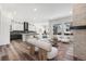 Open-concept living area with hardwood floors, a fireplace, and an adjacent kitchen creates a great flow at 9688 Winterset Cir, Littleton, CO 80125
