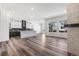 Open-concept living area with hardwood floors, a fireplace, and an adjacent kitchen creates a great flow at 9688 Winterset Cir, Littleton, CO 80125