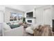 Bright living room features a cozy fireplace and stylish decor, creating an inviting atmosphere at 9688 Winterset Cir, Littleton, CO 80125