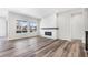 Spacious living room features hardwood floors, a fireplace, and bright, natural light at 9688 Winterset Cir, Littleton, CO 80125