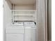 Bright laundry room with washer, dryer and shelving for ample storage space at 7995 E Mississippi Ave # 24, Denver, CO 80247