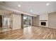 Open living room with fireplace, sliding glass doors and wood-look floors at 7995 E Mississippi Ave # 24, Denver, CO 80247