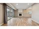 Spacious living room featuring a fireplace, sliding glass doors and wood-look floors at 7995 E Mississippi Ave # 24, Denver, CO 80247