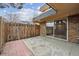 Enclosed patio area featuring brick, wooden fence, and sliding glass doors at 7995 E Mississippi Ave # 24, Denver, CO 80247