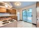 Kitchen with wood cabinets, white appliances, and access to patio at 61 S Sable Blvd # C14, Aurora, CO 80012