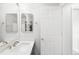 Bright bathroom features double vanity, white cabinets, and modern gold-tone fixtures at 10989 Gaylord St, Northglenn, CO 80233