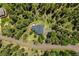 An aerial view of a home nestled among mature trees offering privacy and natural beauty at 30866 Kings Valley Way, Conifer, CO 80433