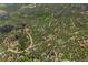 A scenic aerial shot of a community with homes scattered amongst dense trees at 30866 Kings Valley Way, Conifer, CO 80433