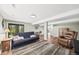 Finished basement with walkout access, neutral paint, and wood laminate flooring at 30866 Kings Valley Way, Conifer, CO 80433