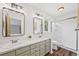 Bathroom boasts dual sinks with marble countertops, tiled shower, and wood-look floors at 30866 Kings Valley Way, Conifer, CO 80433