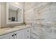 Bright half bath features a vanity with modern fixtures and rustic wood paneling at 30866 Kings Valley Way, Conifer, CO 80433