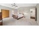 Vaulted bedroom with neutral walls, ceiling fan, walk-in closet and en-suite bathroom at 30866 Kings Valley Way, Conifer, CO 80433