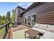 Expansive outdoor deck featuring comfortable lounge seating and a stainless steel grill at 30866 Kings Valley Way, Conifer, CO 80433
