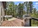 Spacious wooden deck with stainless steel grill and comfortable outdoor furniture at 30866 Kings Valley Way, Conifer, CO 80433