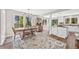 Sunlit dining area with a wooden table, large windows, and scenic views at 30866 Kings Valley Way, Conifer, CO 80433