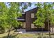 Charming two-story home with wood siding, lush landscaping, and a welcoming front entrance at 30866 Kings Valley Way, Conifer, CO 80433