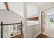 Second floor landing with view of the living area, fireplace and stairwell at 30866 Kings Valley Way, Conifer, CO 80433