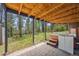 Ground-level patio featuring a hot tub and lush green surroundings at 30866 Kings Valley Way, Conifer, CO 80433