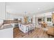 Open concept kitchen with island, stainless steel appliances, and seamless flow to dining and living areas at 30866 Kings Valley Way, Conifer, CO 80433