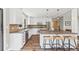 Spacious kitchen features white cabinets, modern appliances, and a large island with seating at 30866 Kings Valley Way, Conifer, CO 80433