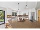 Well-lit kitchen features a large island with seating, stainless steel appliances, and ample counter space at 30866 Kings Valley Way, Conifer, CO 80433