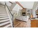 Bright living room featuring a staircase, stone fireplace, and hardwood floors at 30866 Kings Valley Way, Conifer, CO 80433
