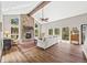 Inviting living room with stone fireplace, vaulted ceilings, wood floors, and bright windows at 30866 Kings Valley Way, Conifer, CO 80433