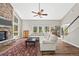 Spacious living room with stone fireplace, wood floors, and lots of natural light at 30866 Kings Valley Way, Conifer, CO 80433