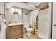 Bathroom features a vanity, toilet, and shower with stylish curtain at 12718 W 84Th Dr, Arvada, CO 80005