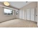 Bright bedroom with large windows and double closets, plus neutral carpet at 12718 W 84Th Dr, Arvada, CO 80005