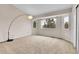 Bright bedroom with large windows and a contemporary floor lamp, plus neutral carpet at 12718 W 84Th Dr, Arvada, CO 80005