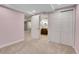 Bedroom with neutral carpet, a closet, and a view into the bathroom at 12718 W 84Th Dr, Arvada, CO 80005
