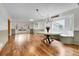 Open dining area with hardwood floors, a round table, and natural light from the large windows at 12718 W 84Th Dr, Arvada, CO 80005