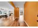 Bright foyer featuring hardwood floors, bold accent walls, and an inviting view into the dining area at 12718 W 84Th Dr, Arvada, CO 80005