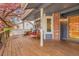 Inviting front porch with ample seating, decorative pillows, and a clear view of the neighborhood at 12718 W 84Th Dr, Arvada, CO 80005