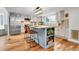 Modern kitchen with an island, stainless steel appliances, and ample counter space for cooking and entertaining at 12718 W 84Th Dr, Arvada, CO 80005