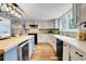 Bright kitchen with a center island, modern appliances, and stylish lighting fixtures at 12718 W 84Th Dr, Arvada, CO 80005