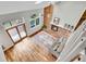 An aerial view of the living room with a brick fireplace, vaulted ceiling, and wood floors at 12718 W 84Th Dr, Arvada, CO 80005