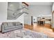 Open living room features a staircase and views into the kitchen at 12718 W 84Th Dr, Arvada, CO 80005