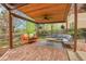 Outdoor patio with a seating area, a swing, and brick flooring at 12718 W 84Th Dr, Arvada, CO 80005