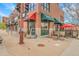 Jack's is a neighborhood eatery with outdoor seating with red umbrellas on a sunny day at 12718 W 84Th Dr, Arvada, CO 80005