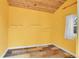 Small yellow room with tile floor, shelving, and a window at 12718 W 84Th Dr, Arvada, CO 80005