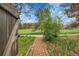 Brick path leading to a yard with green grass and trees at 12718 W 84Th Dr, Arvada, CO 80005