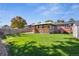A spacious backyard with a well-maintained lawn, a covered patio, and a storage shed at 7910 Hooker St, Westminster, CO 80030